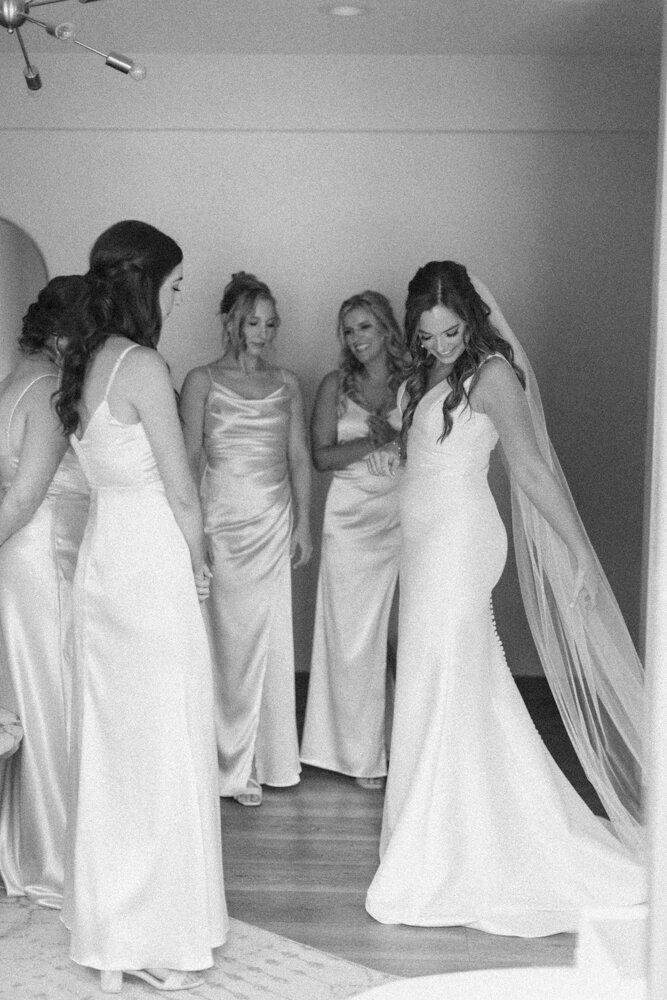 bridesmaids admiring bride in gown
