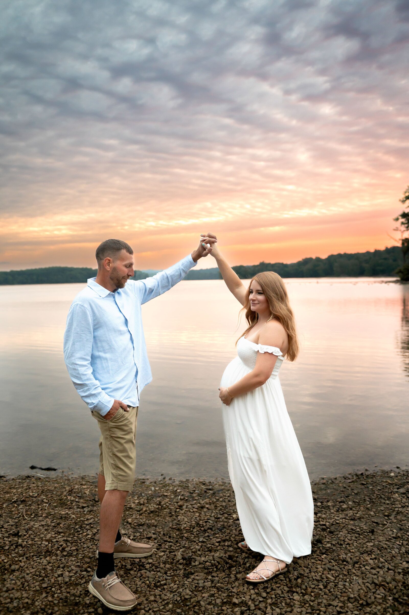 couple dancing at sunset on water