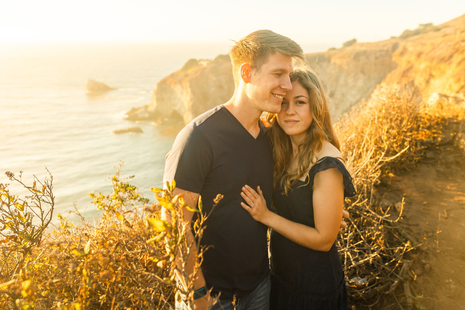 A couple poses for their engagement photos in Big Sur, California.