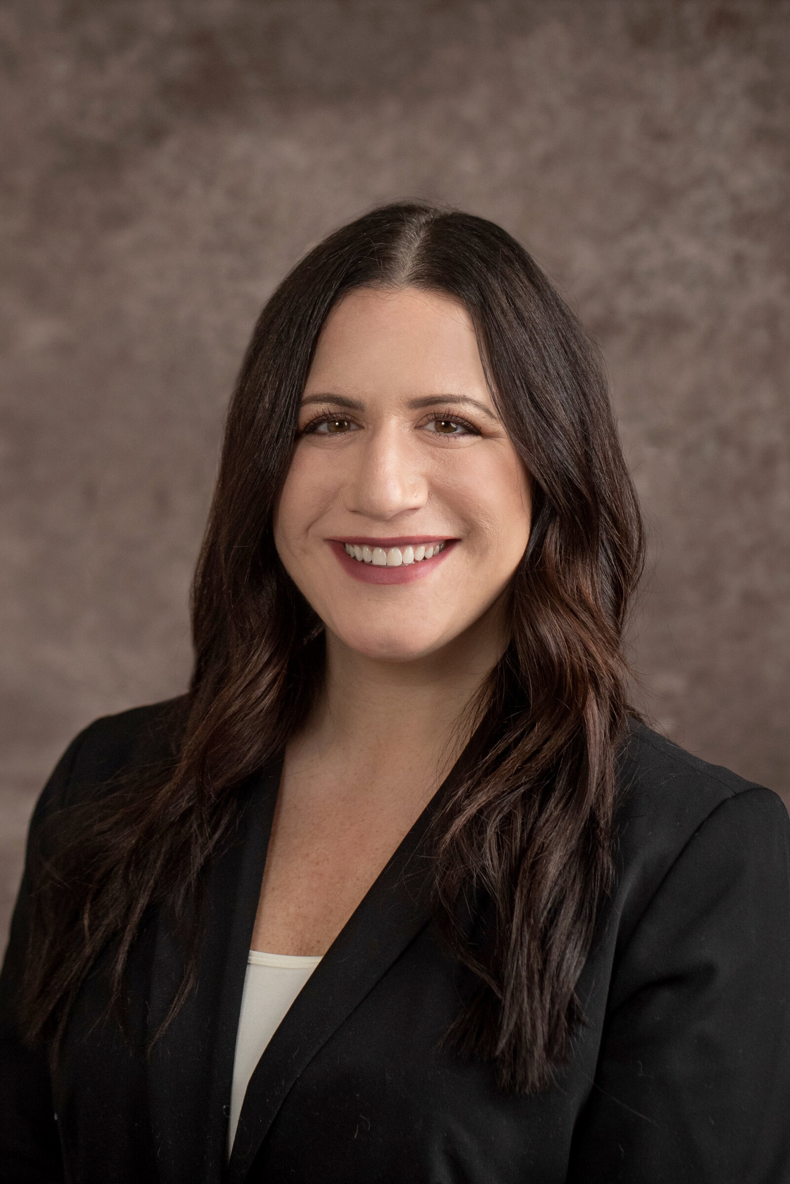woman smiles in business headshot