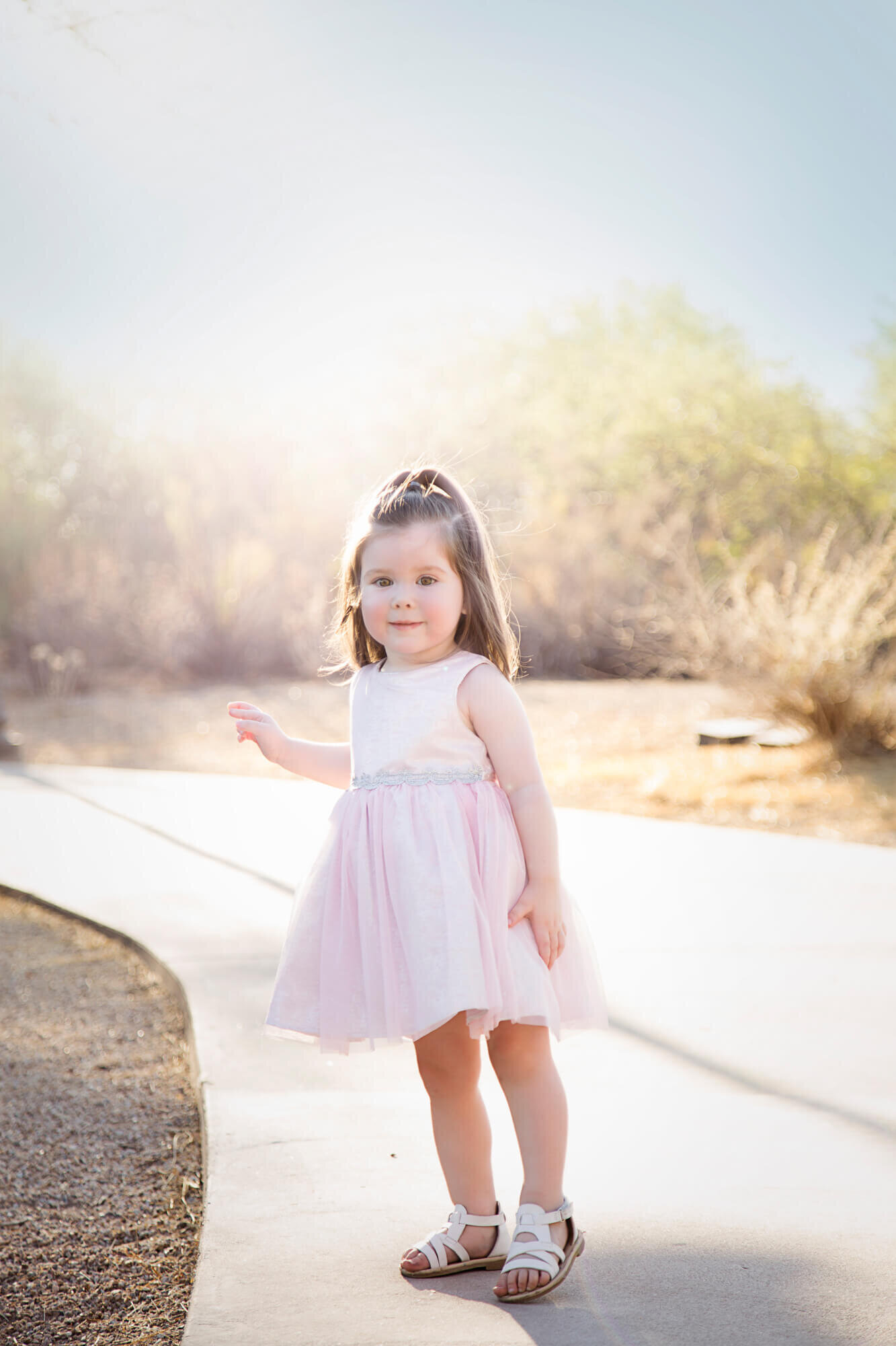 toddler girl in a stunning haze of light on a park path during session with las vegas milestone photographer, Jessica Bowles