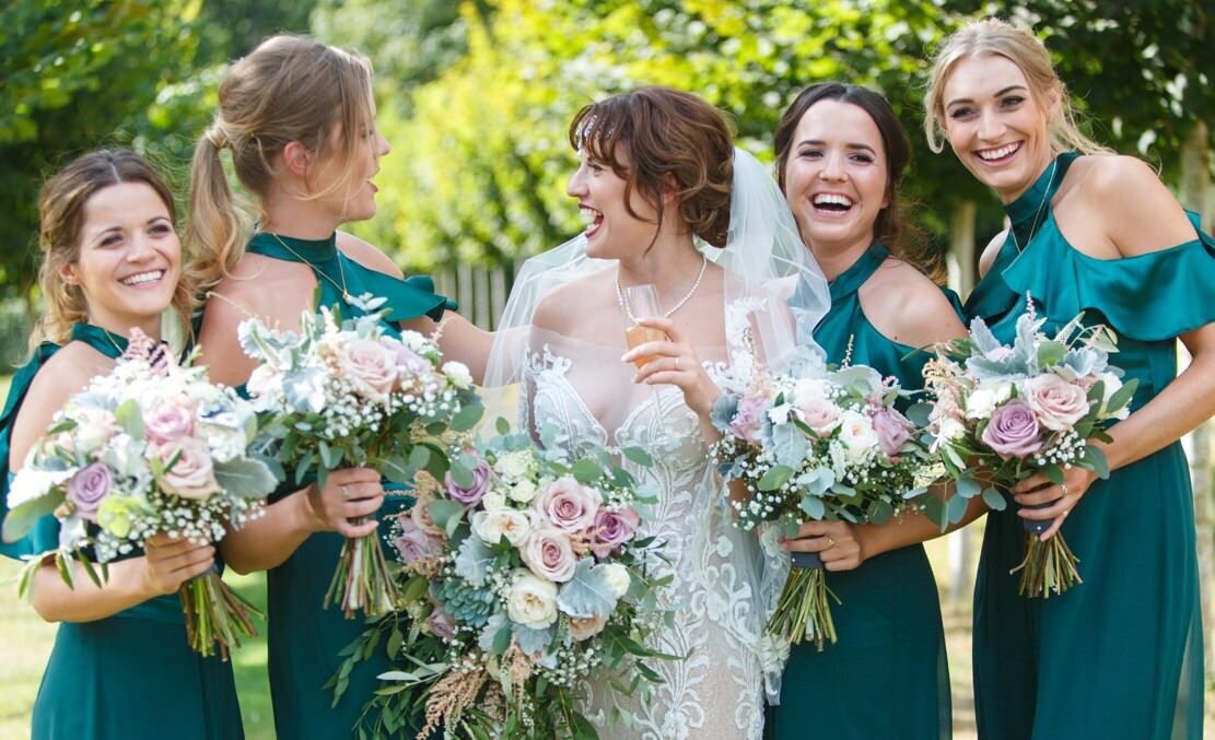 green dresses bridal party happy smiling hairstyles updo