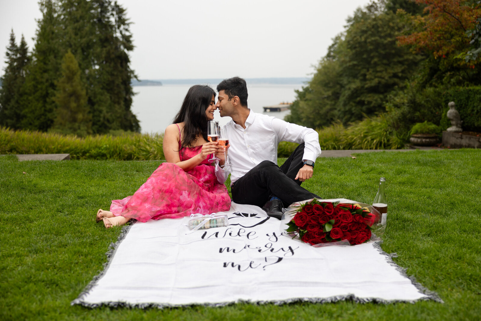 Gig Harbor and Bainbride Island surprise wedding proposal session couple toasting with champaign