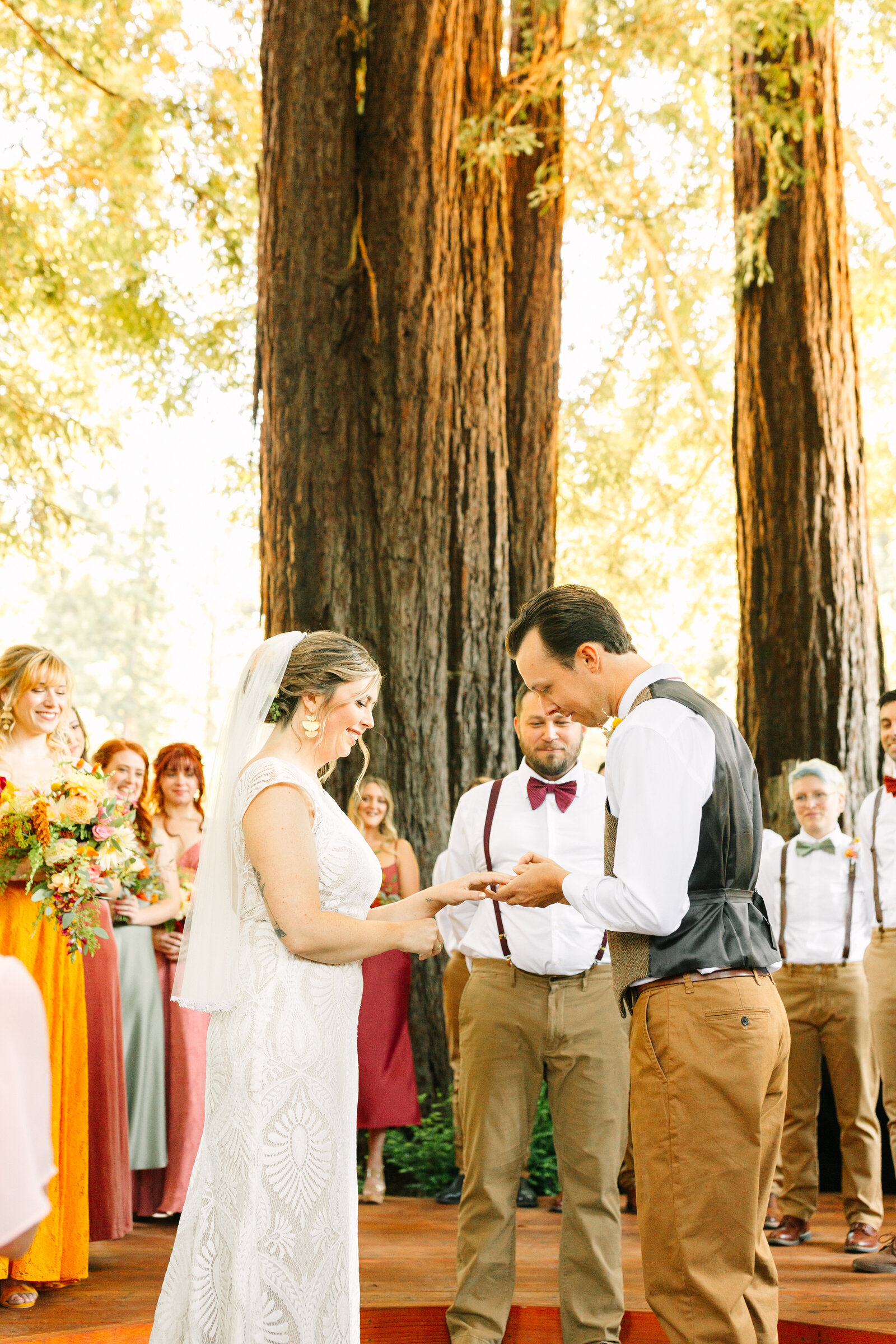 Bride and groom at their colorful wedding ceremony in Santa Cruz, California in the redwood trees.
