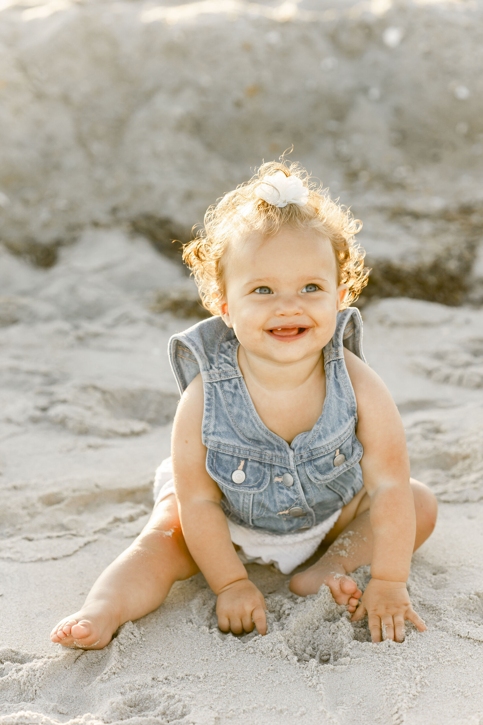 photo of baby sitting on the beach in long beach island new jersey taken by photographer ally kimpton 