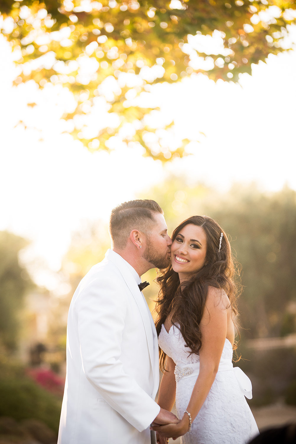 groom kissing brides cheek