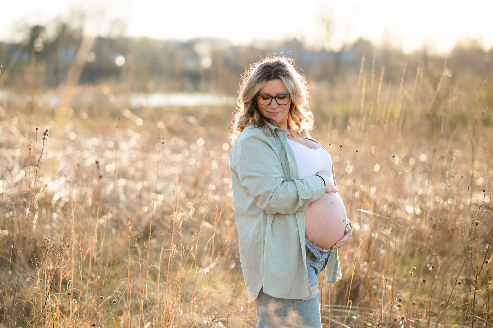 Outdoor session mother holding belly