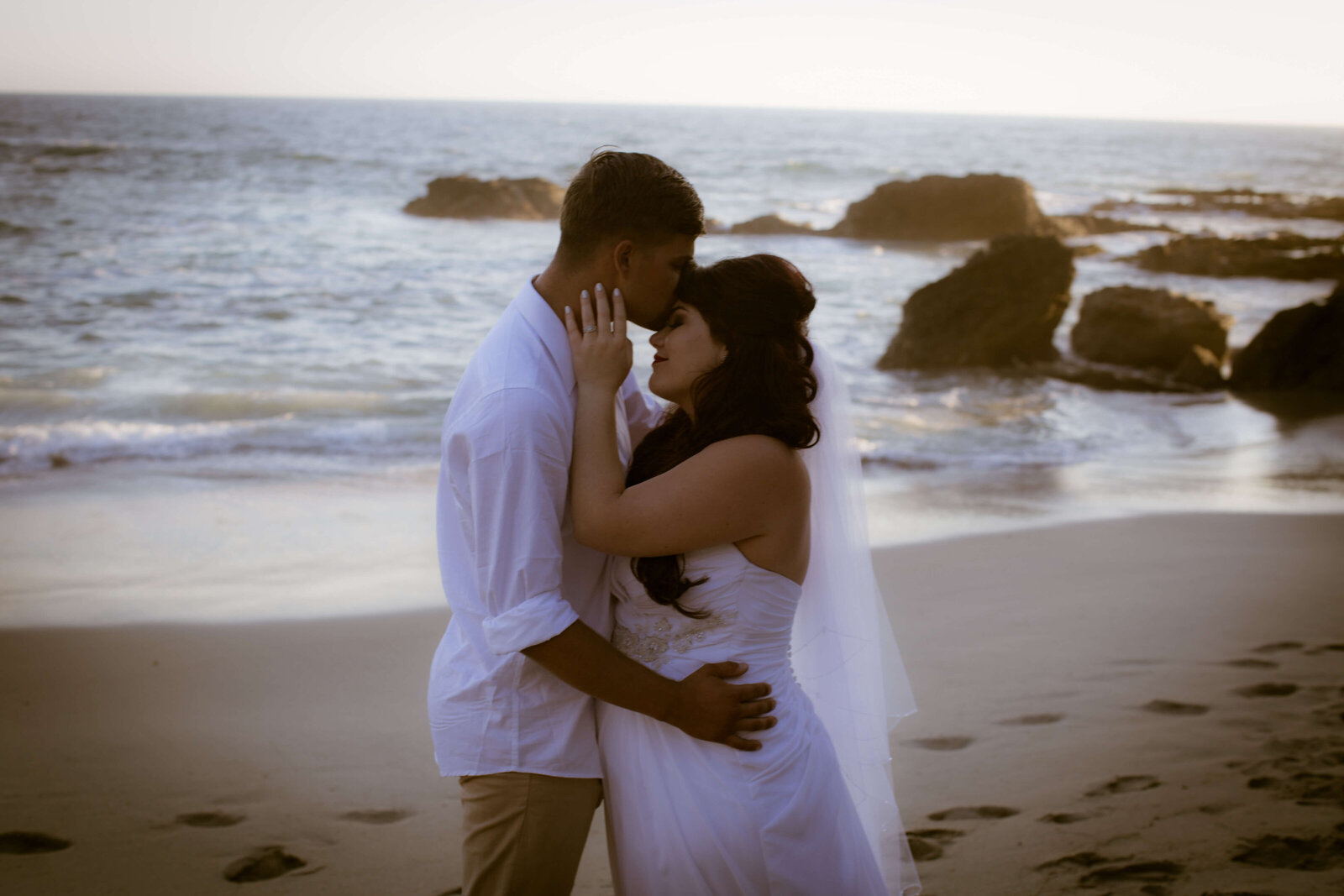 KS Gray Photography Newport Beach Bride and groom in front of ocean on beach