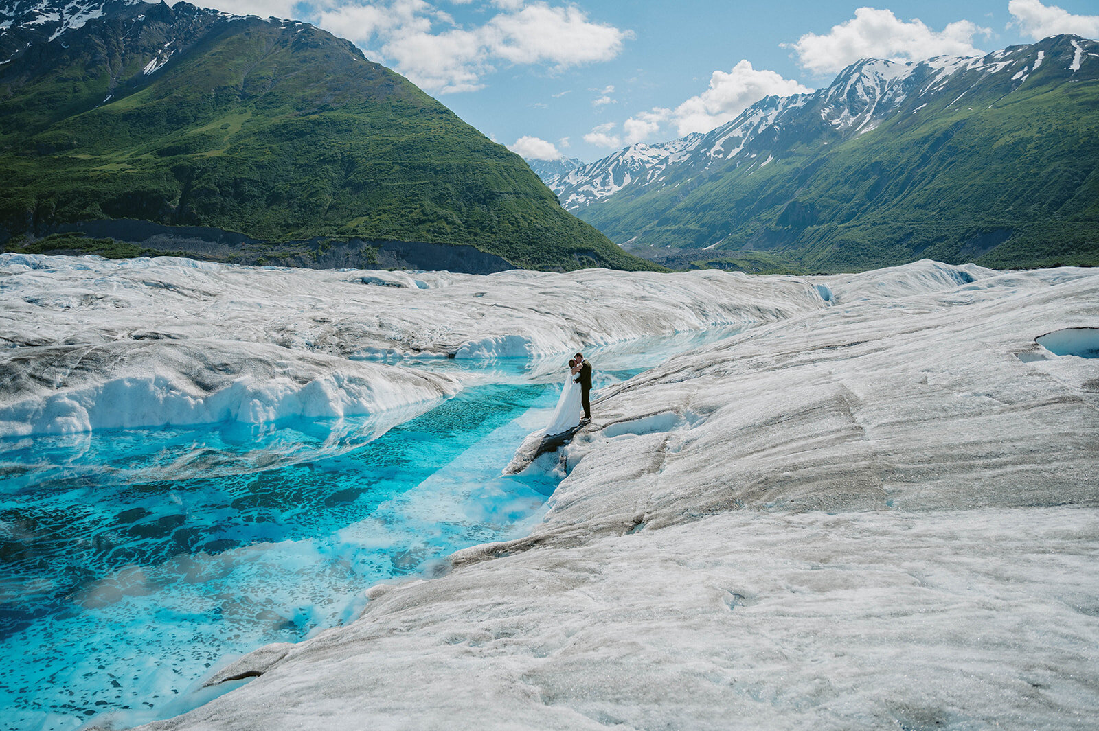 Couple stand on the glacier in Alaska