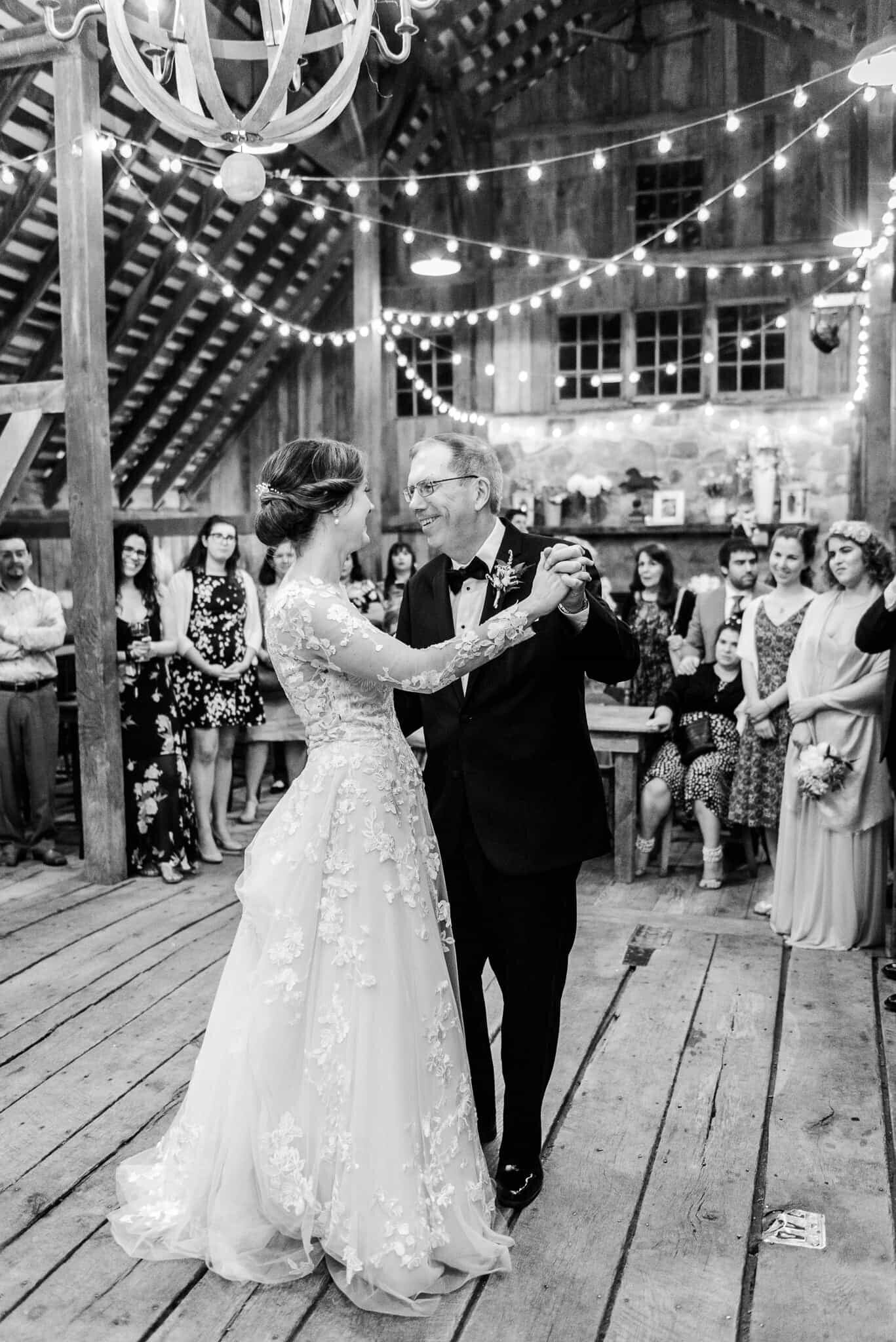 A bride dancing with her father during a wedding at The Barns at Hamilton Station Vineyard in Loudoun County