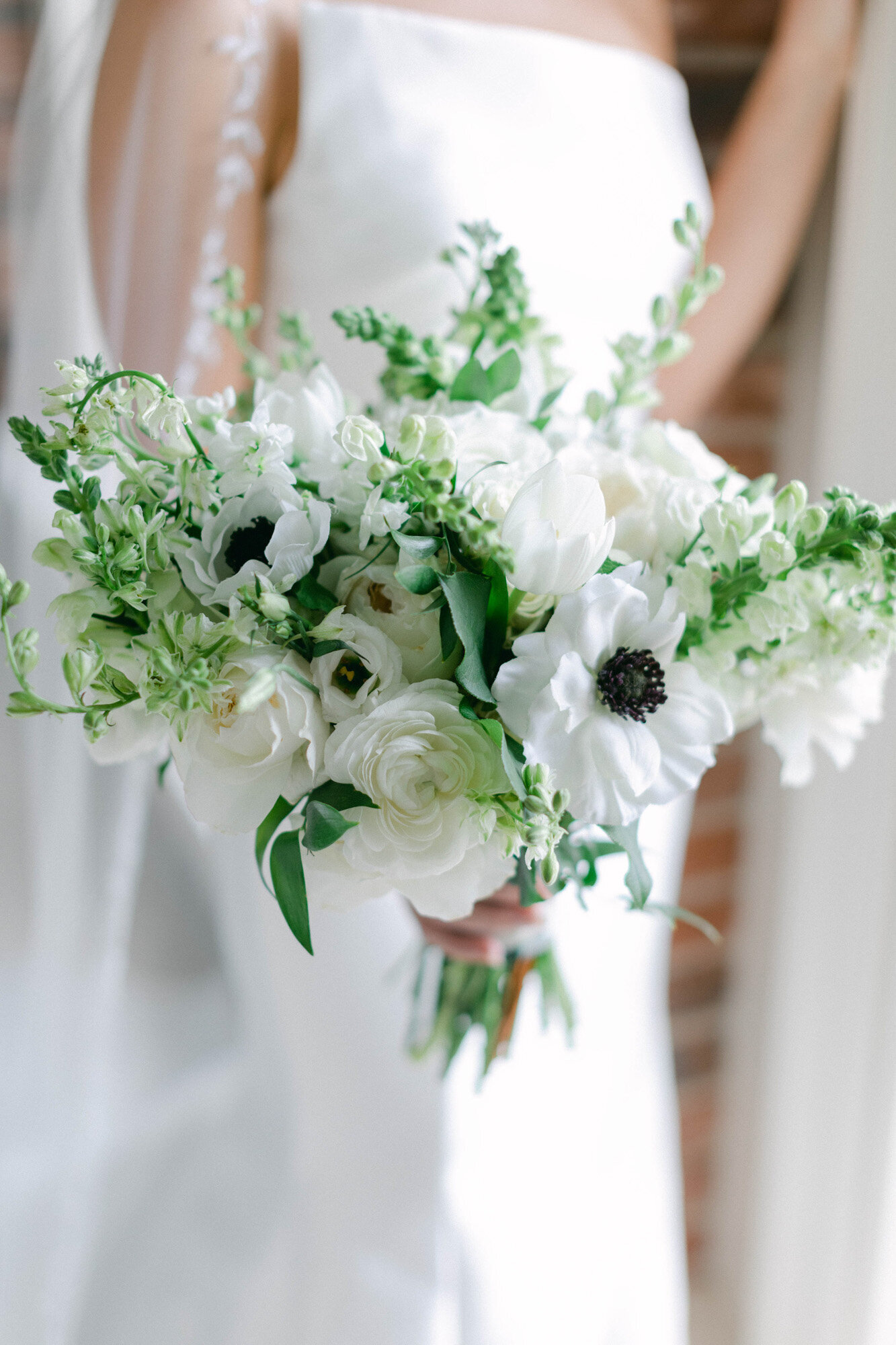 bride holding white floral bouquet