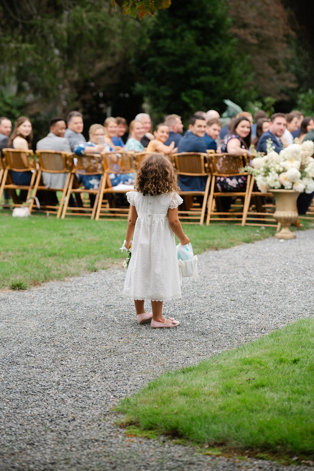 flower girl from behind paused down aisle