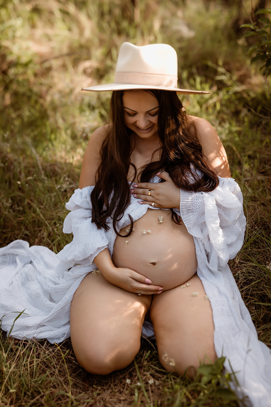 Mother holding her baby bump for maternity photography session in Springfield