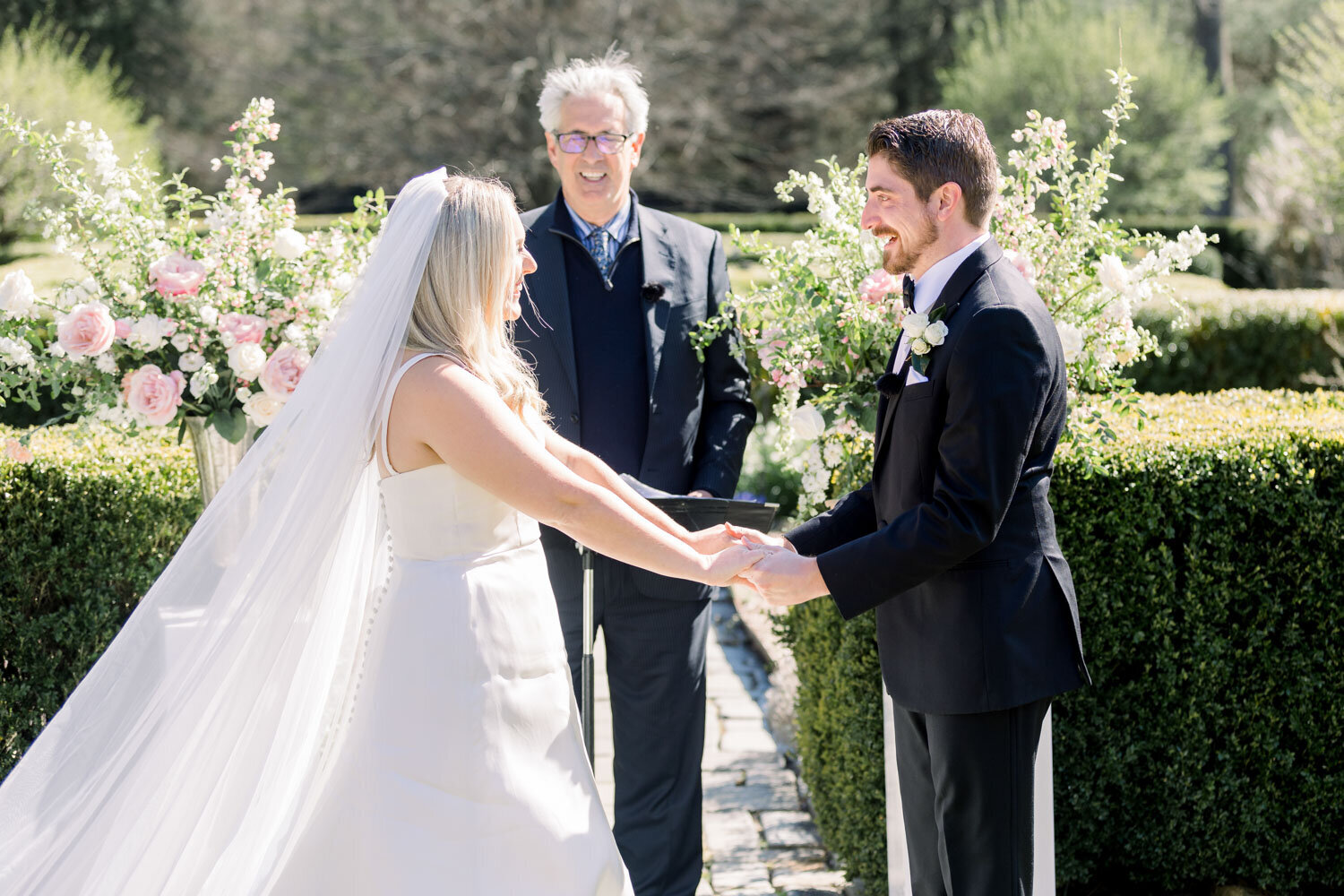 Bride and groom holding hands during wedding ceremony