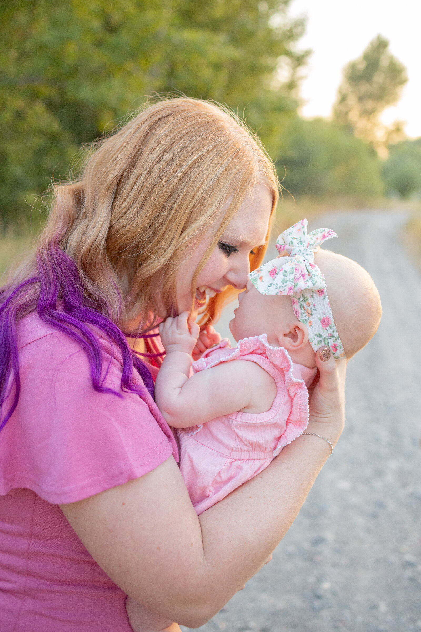 Seattle Wedding Photographer captures mom holding baby while touching noses and smiling
