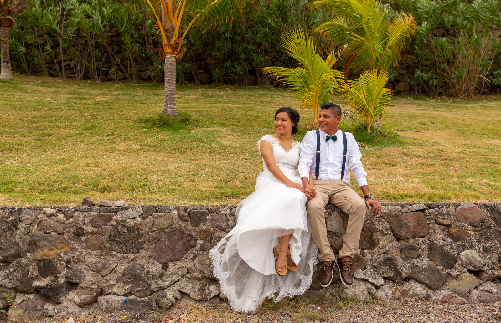 A bride and groom sit in the jungle during their Nicaragua elopement