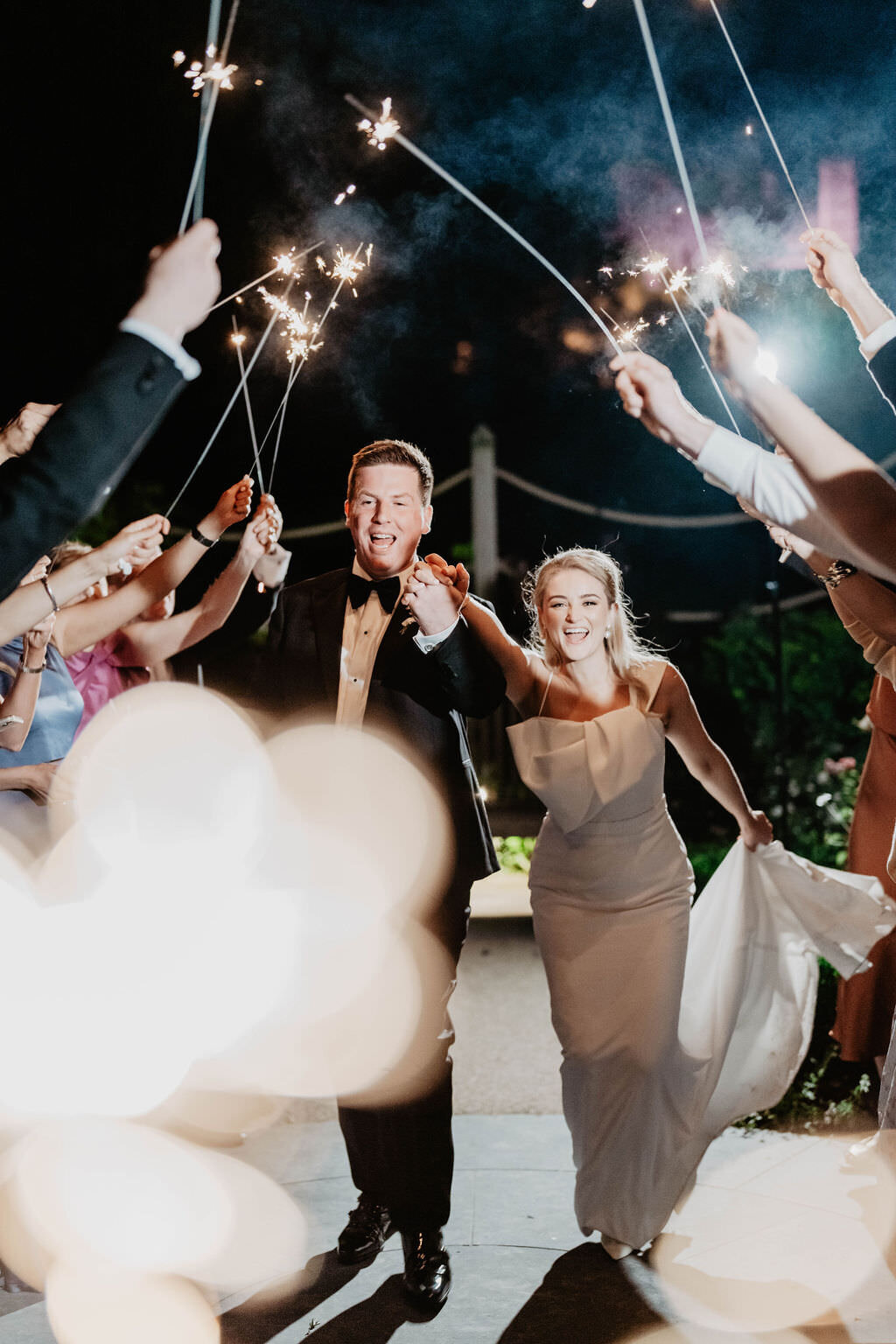 Bride and groom leaving their wedding with a sparkler exit