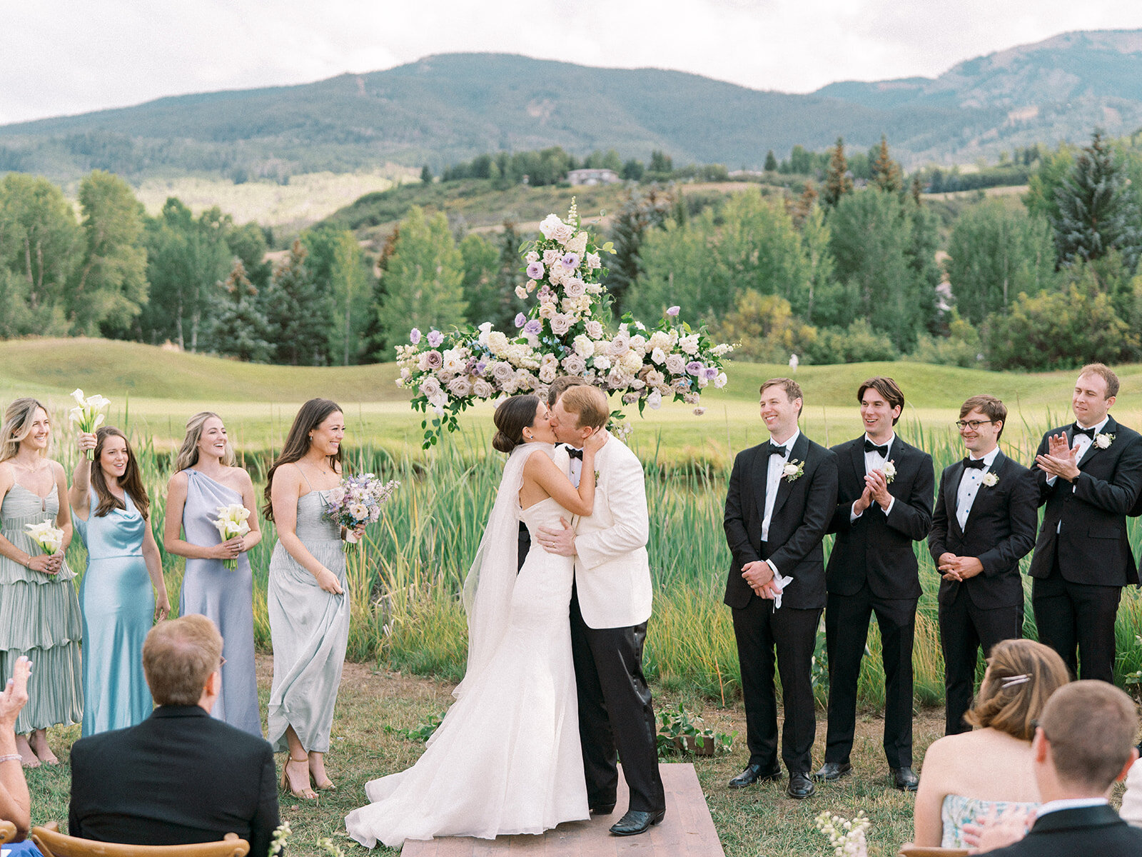 Bride and groom kiss at the conclusion of their wedding ceremony