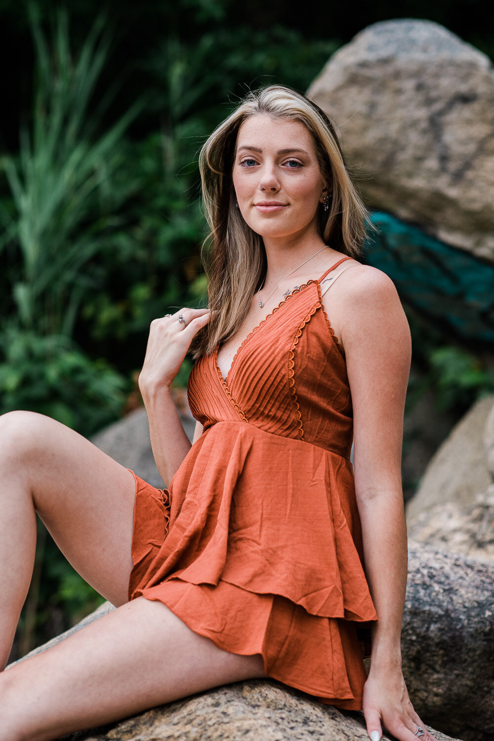 grad girl sitting on rock