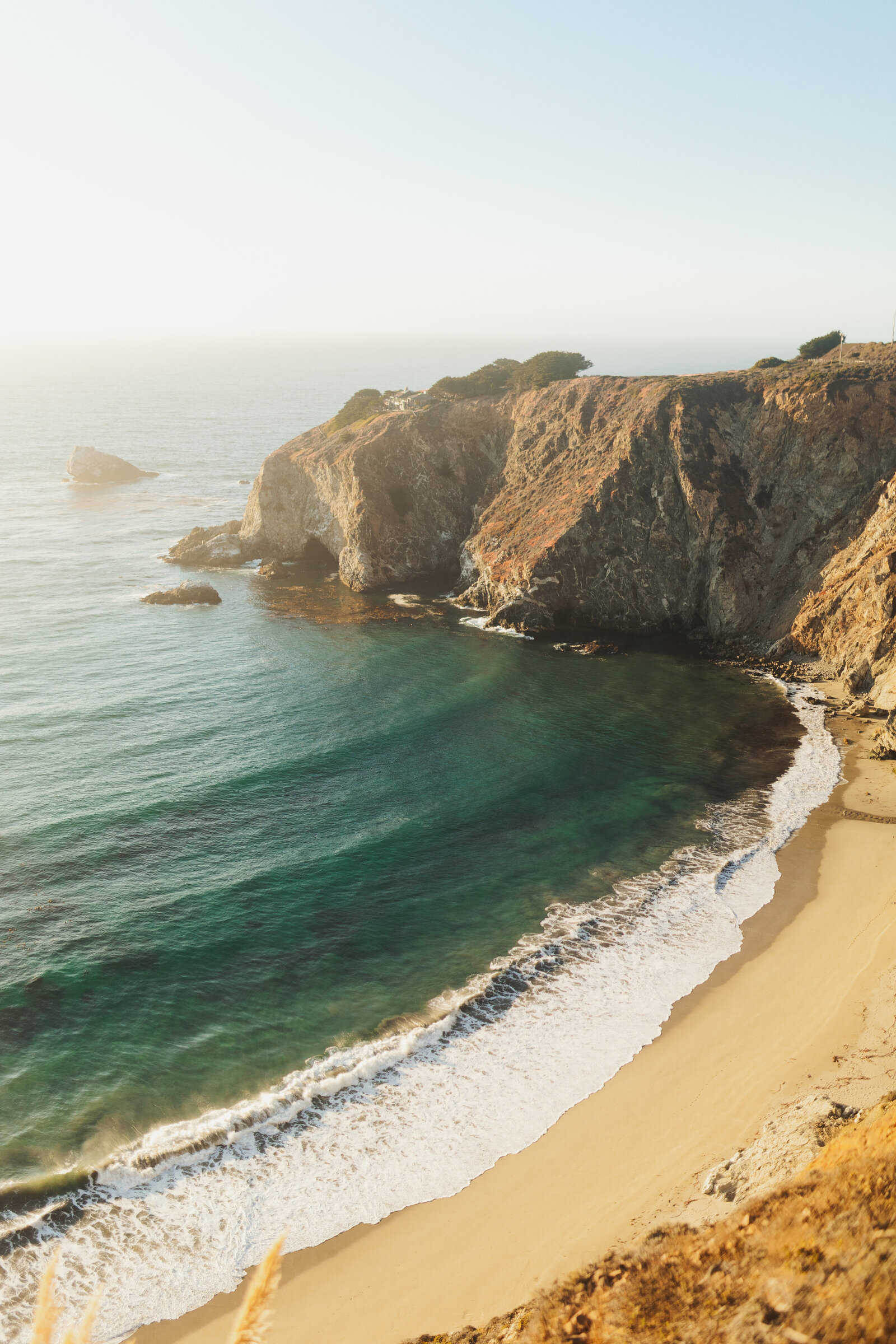 A couple poses for their engagement photos in Big Sur, California.