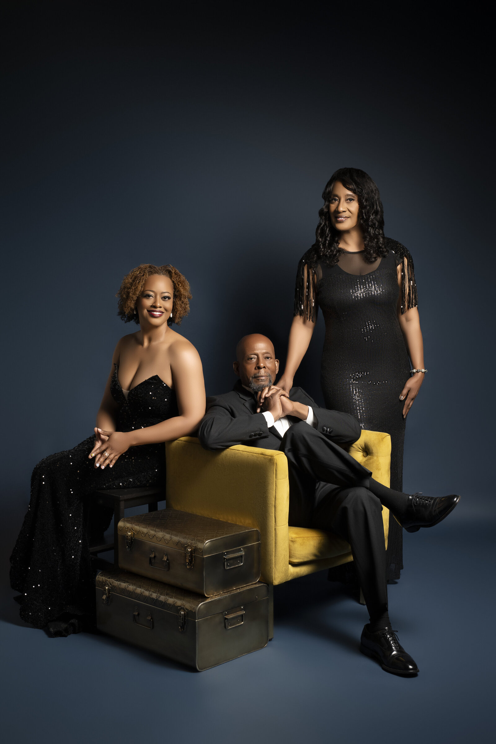 Black family shows black excellence posing with adult daugher. 