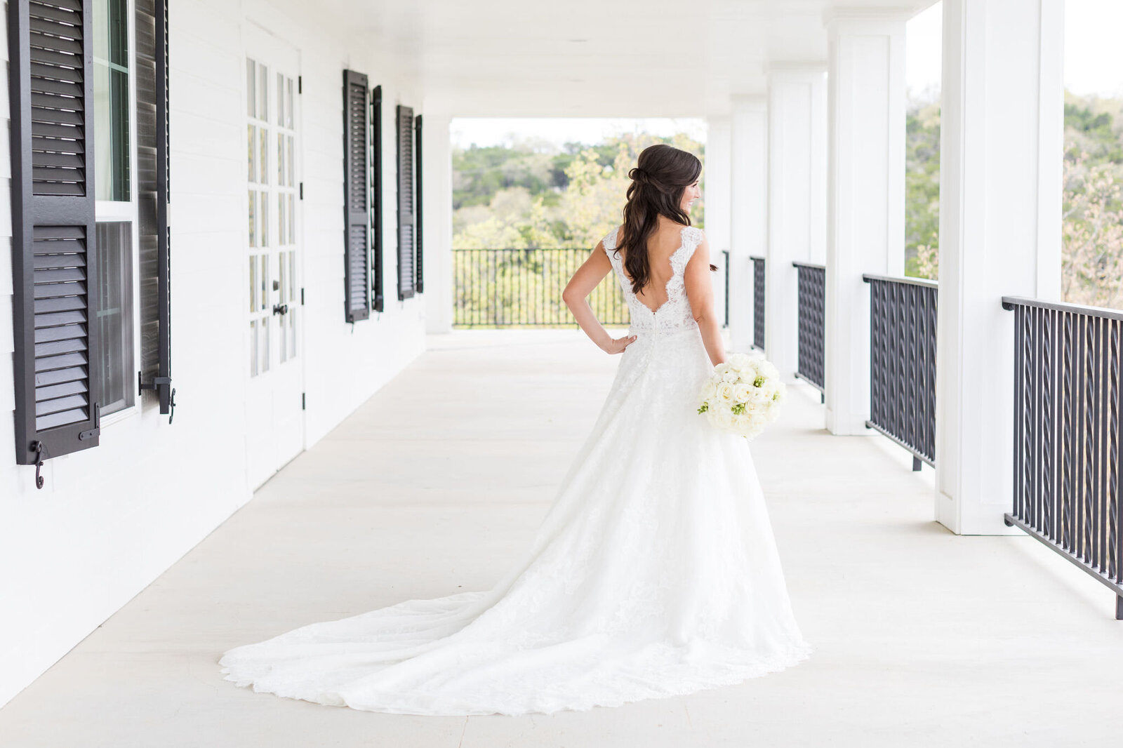 A bride looks over the Kendall Point balcony before her wedding.