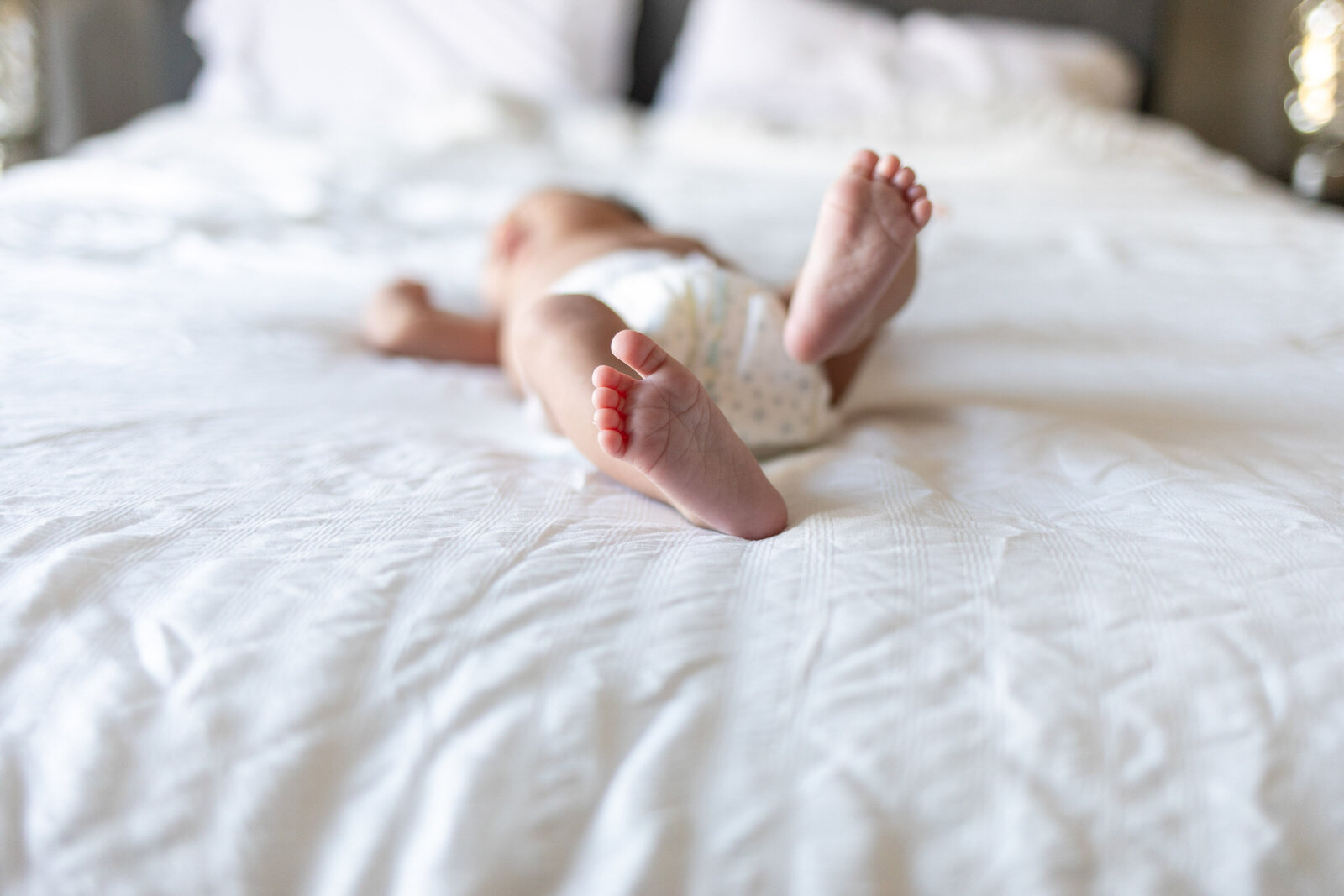 Kansas_City_Newborn_Photography_baby_toes_laying_on_bed-5
