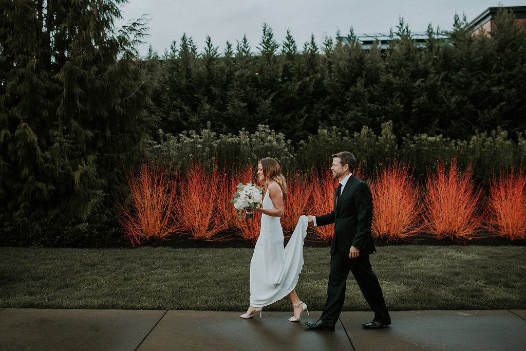 Bride and groom walking with white floral