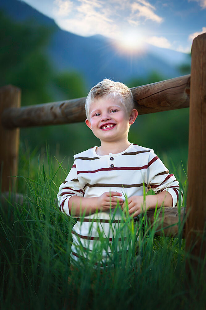 colorado-mountain-kid-live-here-missing-tooth-blond-boy-cute-fence-rustic-sunset-colorful-best-child-portrait