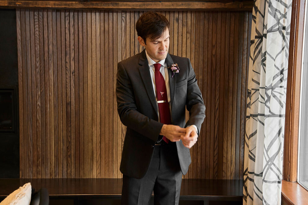 groom-getting-ready-black-suit-burgundy-tie