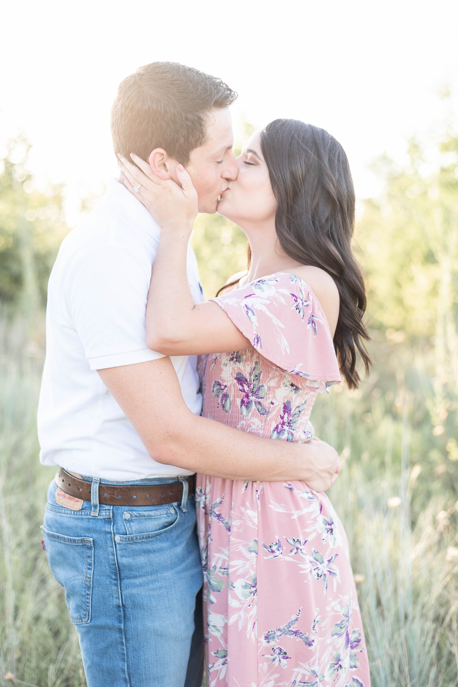 couple shares a passionate kiss at sunset