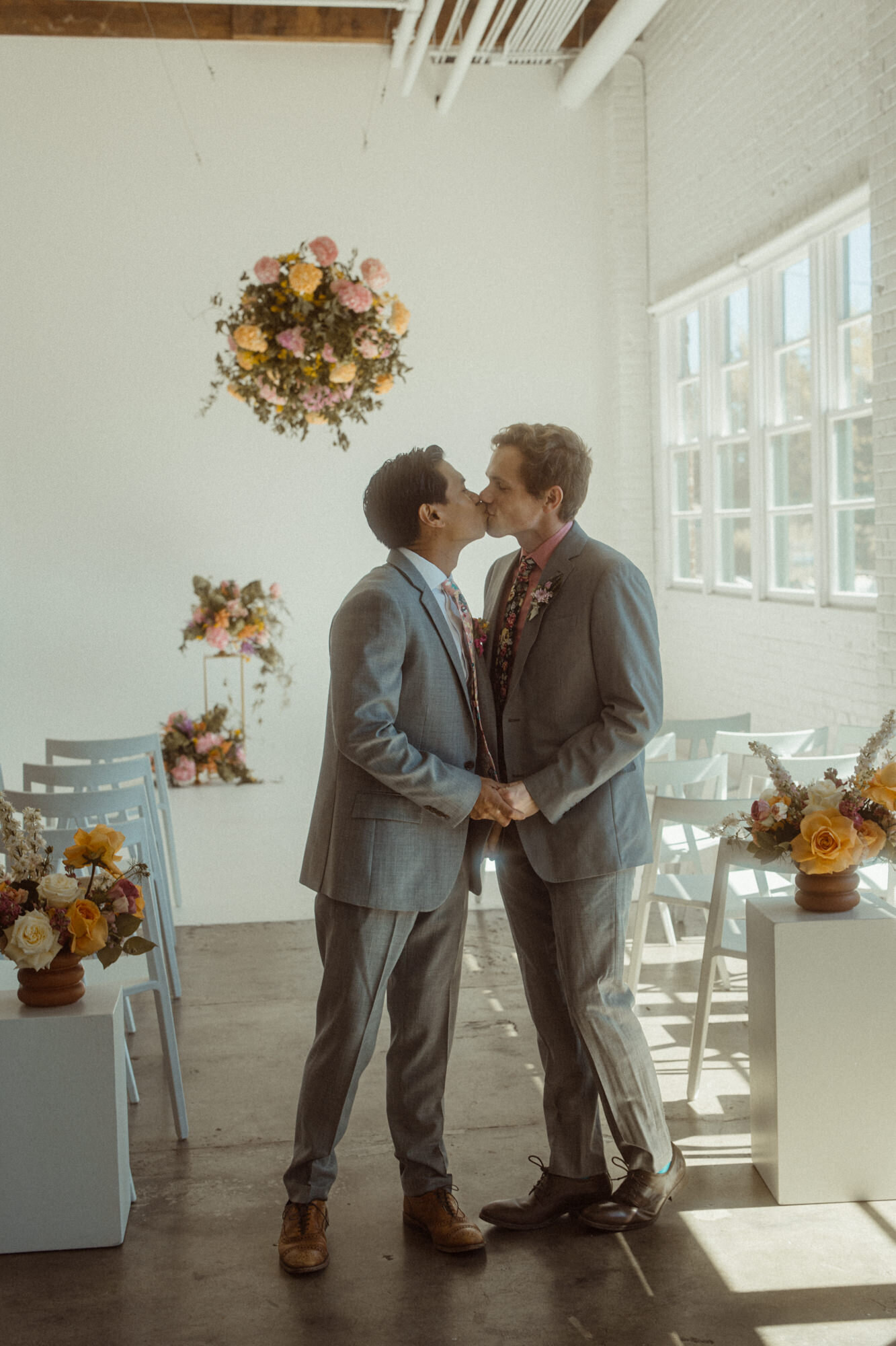 Two grooms kissing.