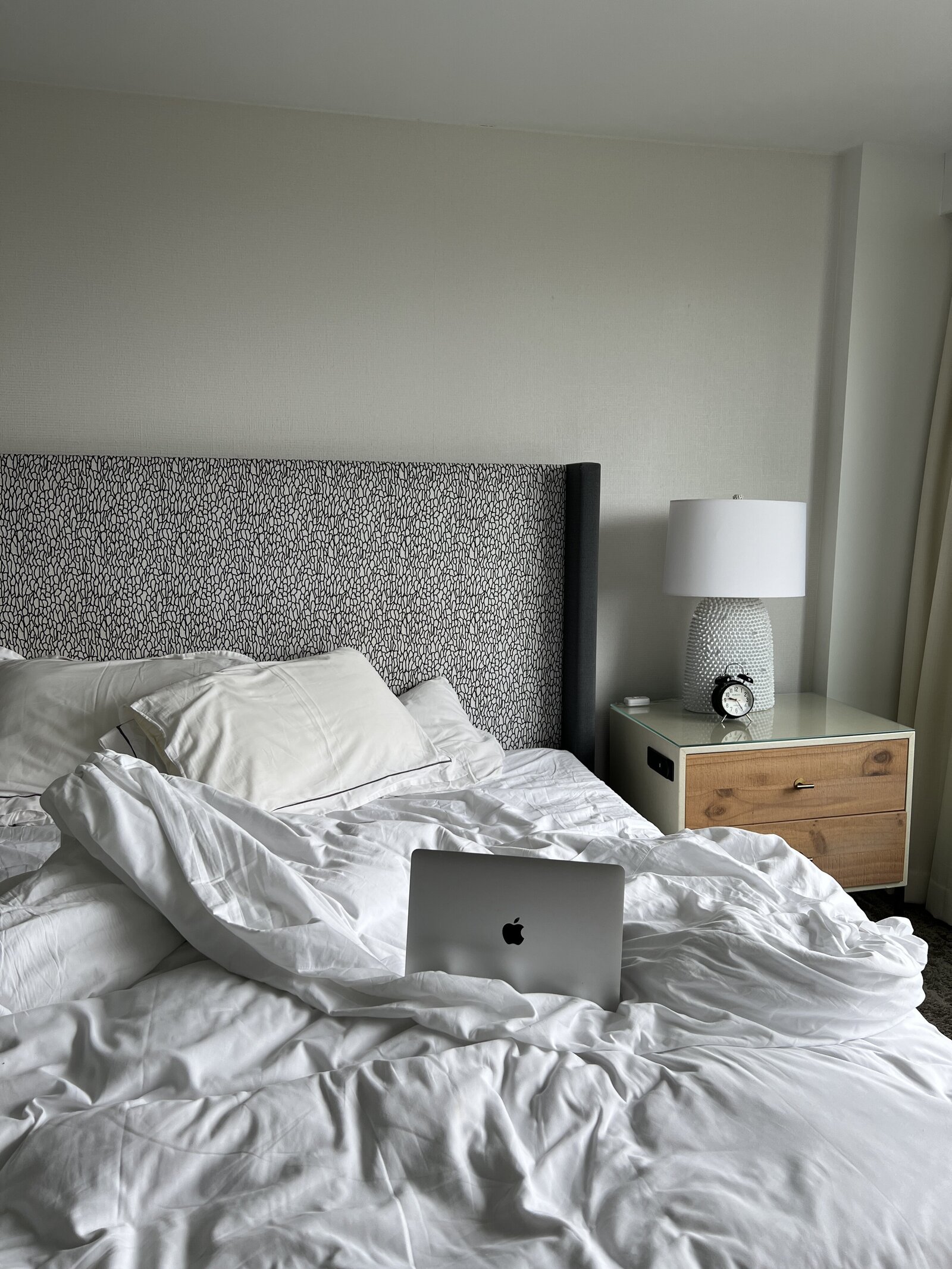 macbook sitting on hotel bed