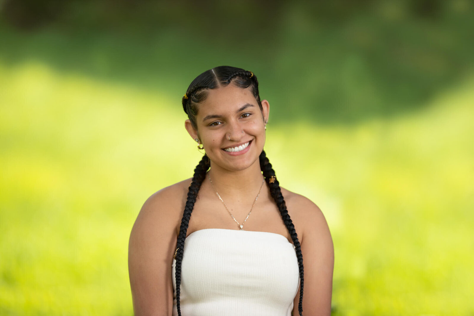 High school senior portrait photography in Clinton MA  of female with two long braids and a silver necklace