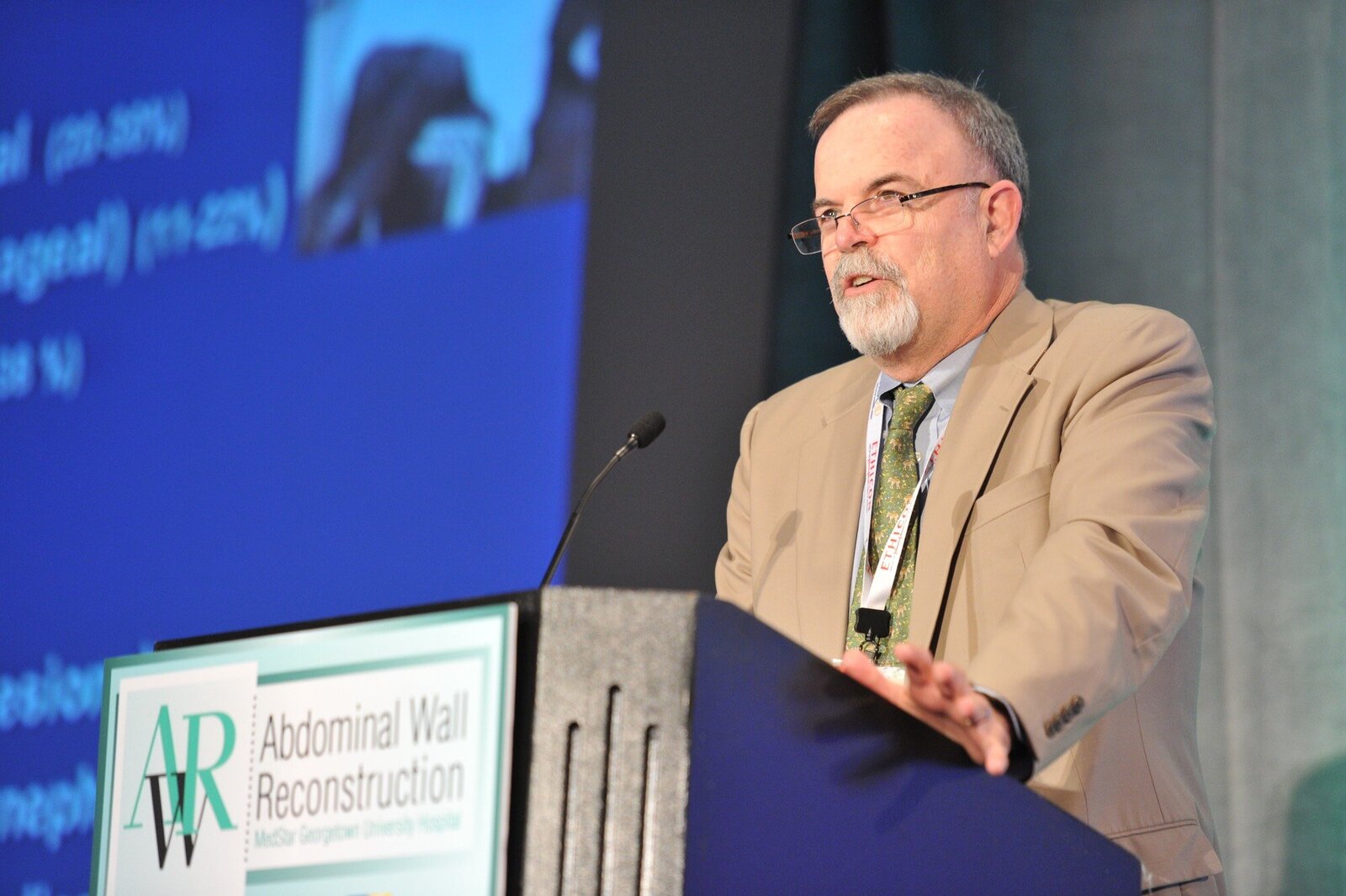 Speaker at podium at medical conference