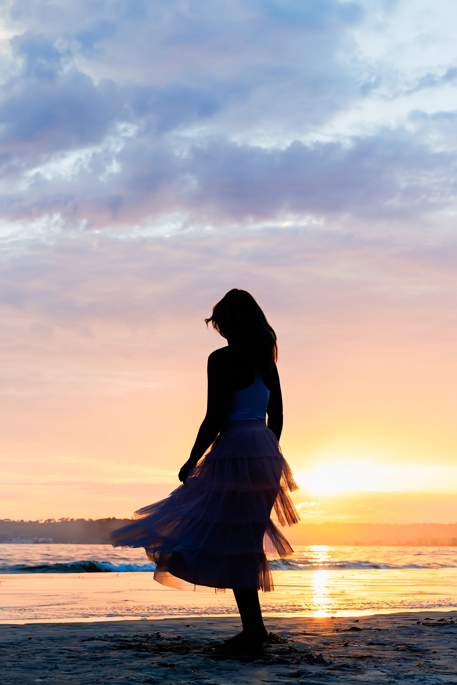 Silhouette portrait of teen girl on the beach