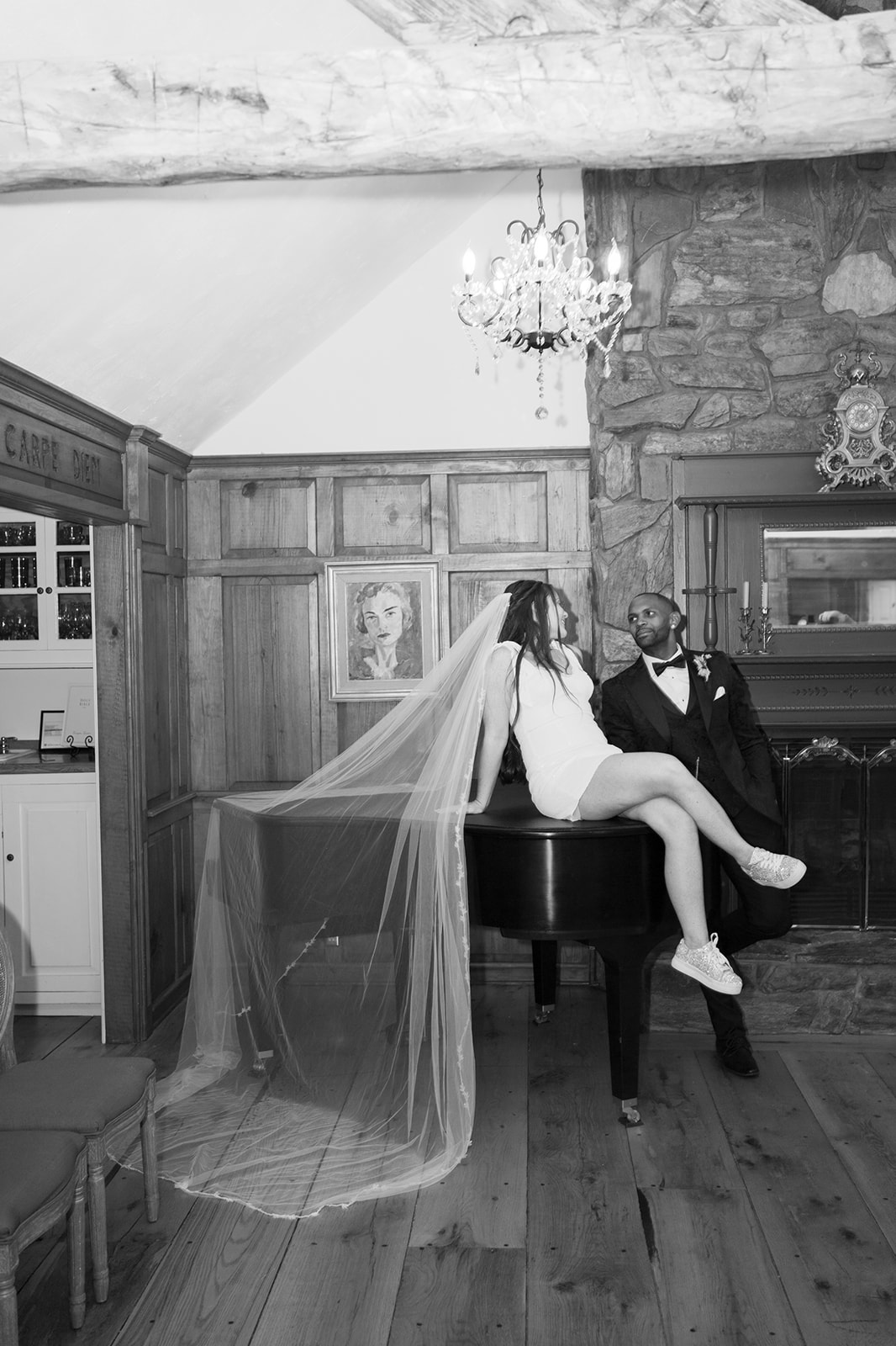 Bride and groom sitting a top piano celebrating their wedding | Megan Smith Photography