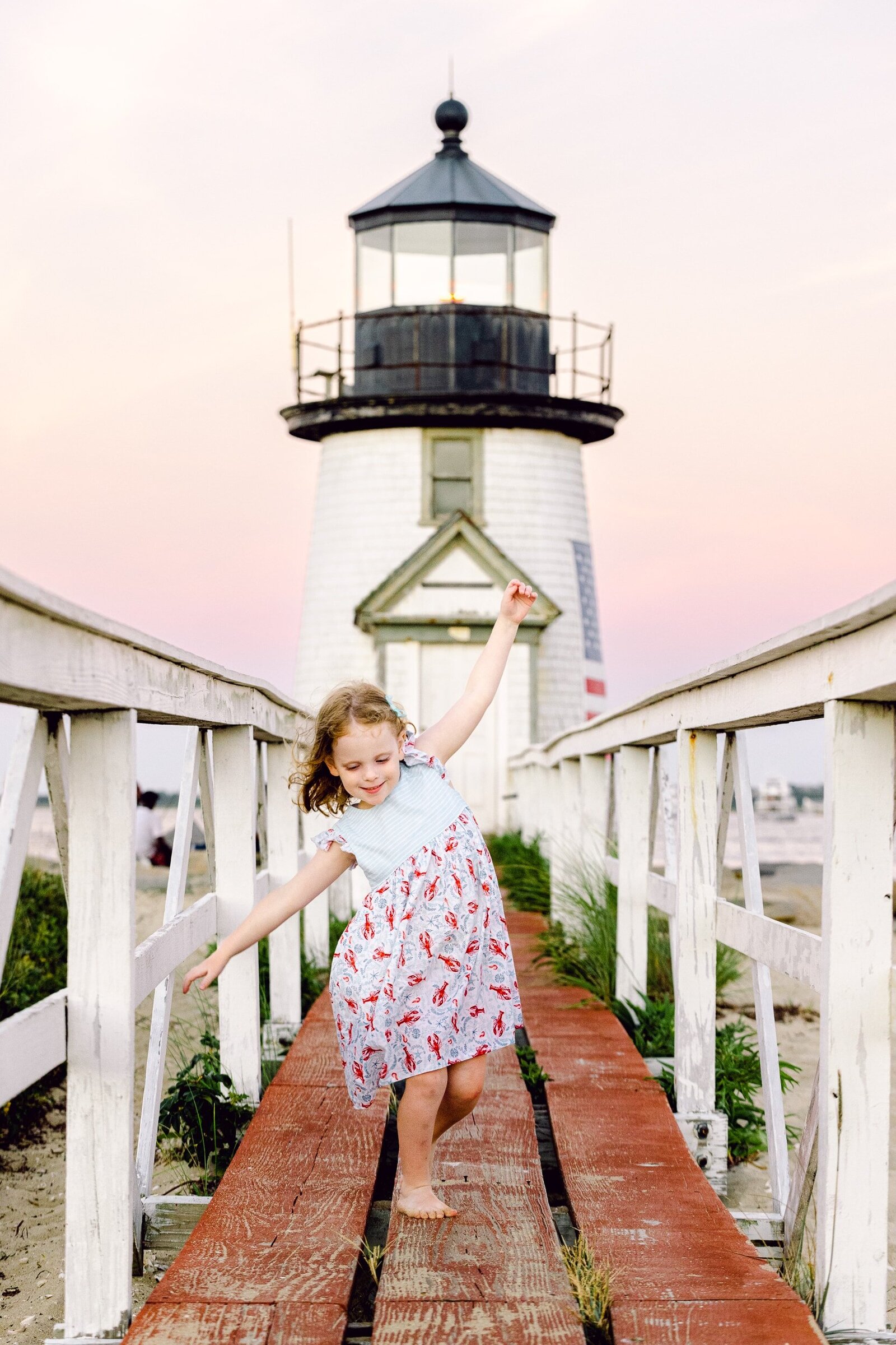 girl dancing at brant point lighthouse
