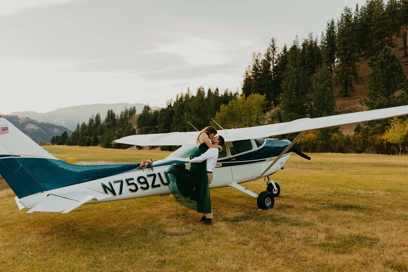 A couple in front of their small plane during their adventure engagement session in Idaho