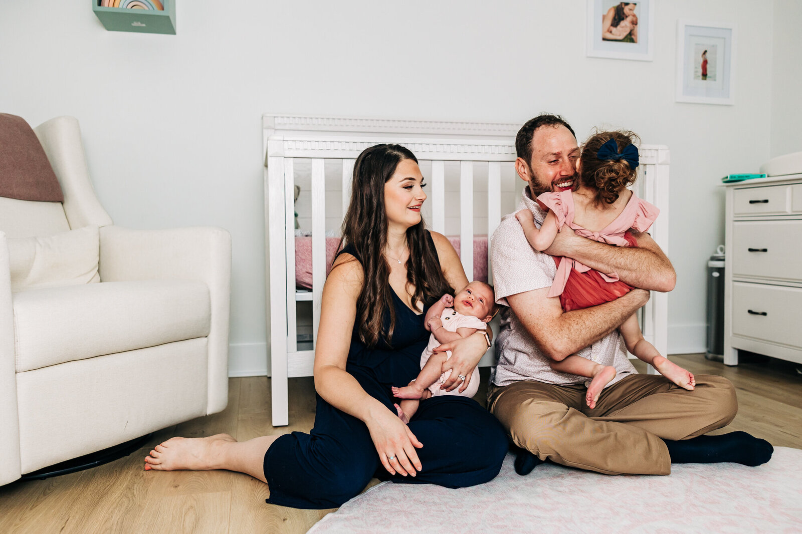 Newborn Photography with big sister in the nursery during a lifestyle in home session