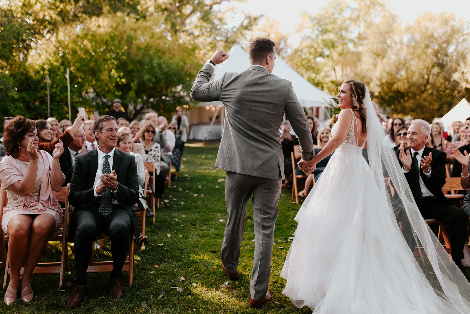 Bride and groom walking down the aisle after being married in outdoor ceremony in Longmont Colorado