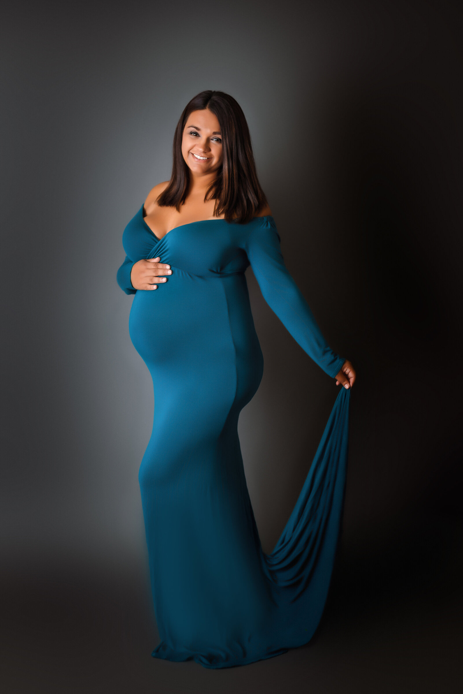 Maternity Photographer, a pregnant mother-to-be wears a blue gown