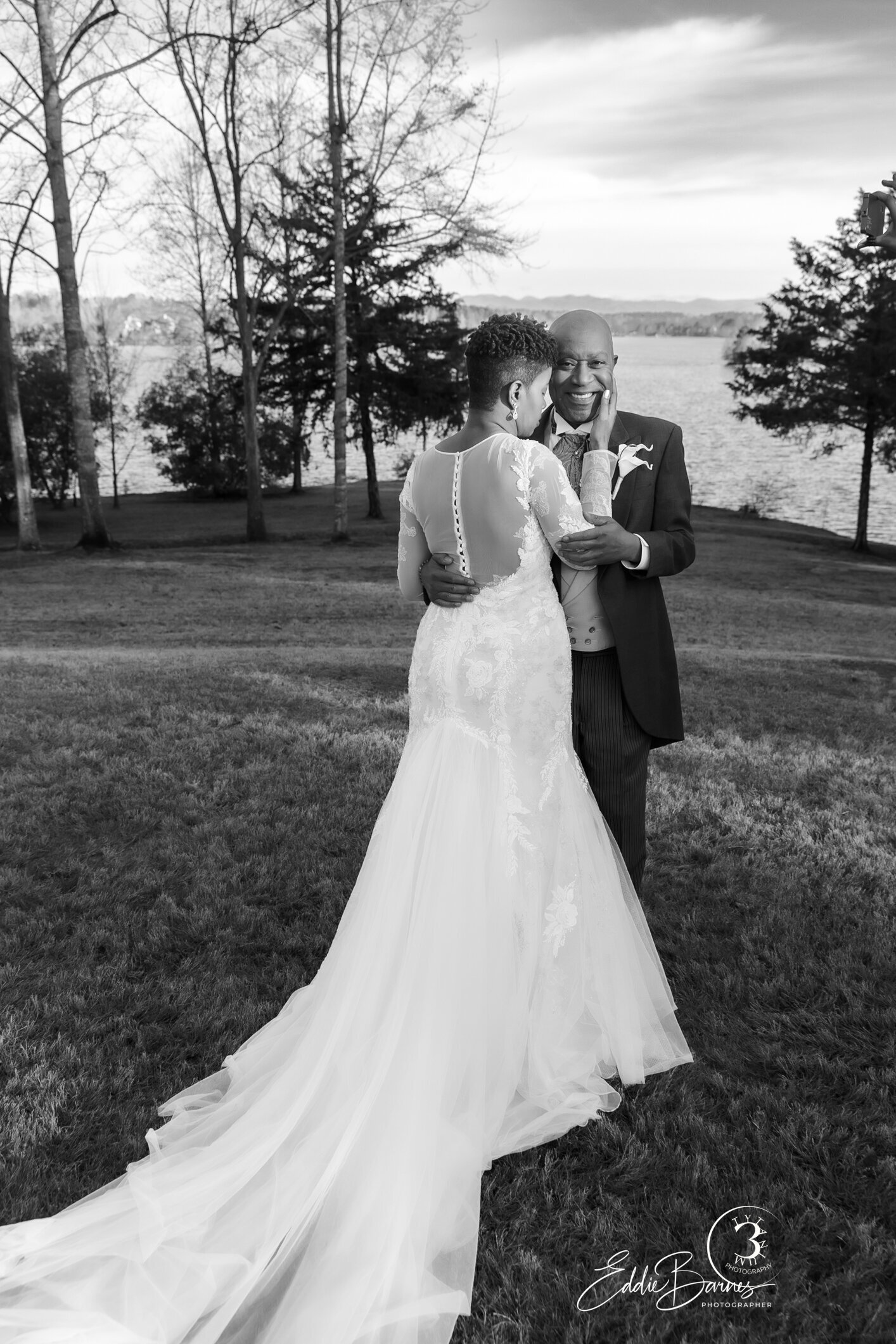 Couple outdoors posing near lake