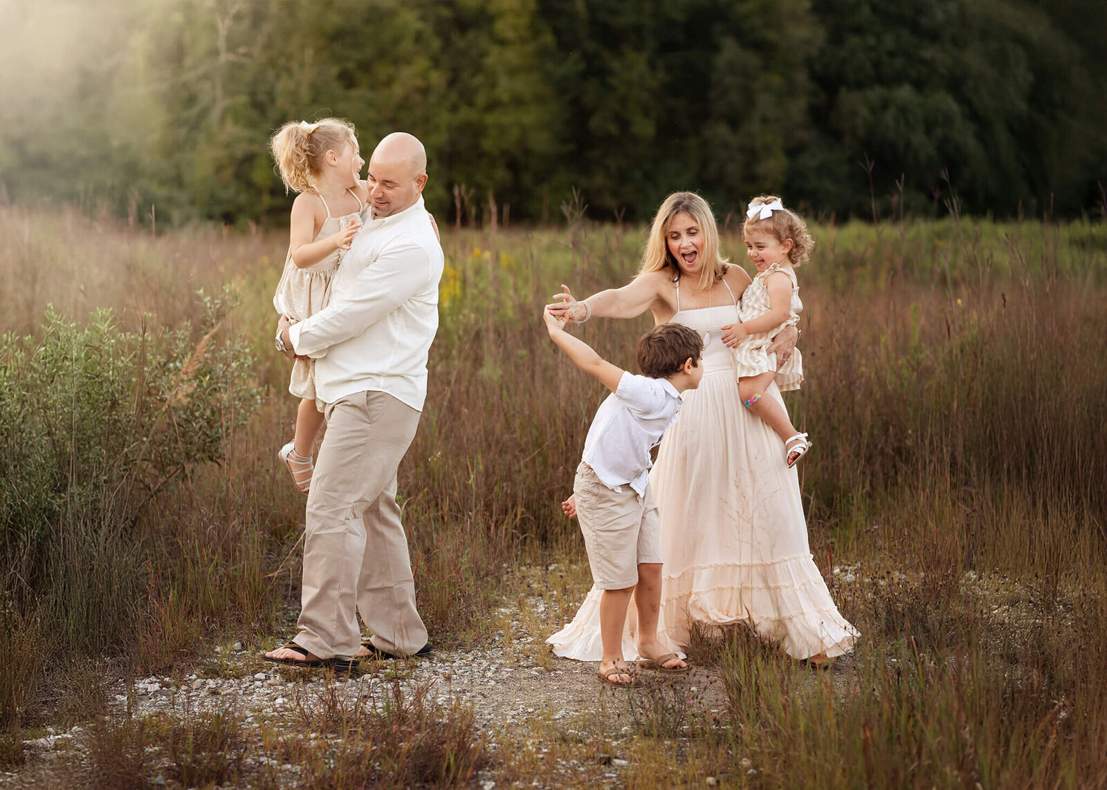 Mom spins her son around while dad dances with daughter