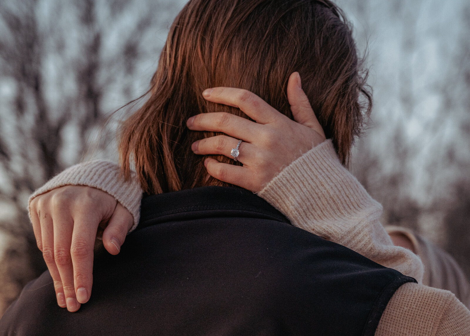 Detail of Promise Ring  on hand behind boyfriends head