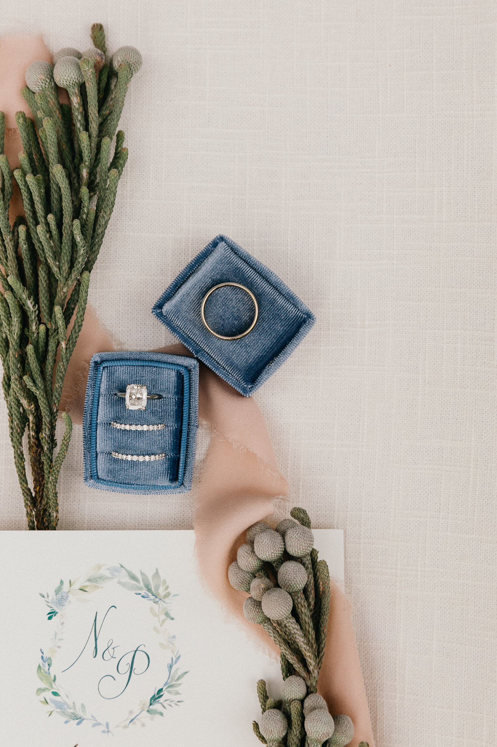 Pastel blue ring box and greenery captured by Philly wedding photographers.