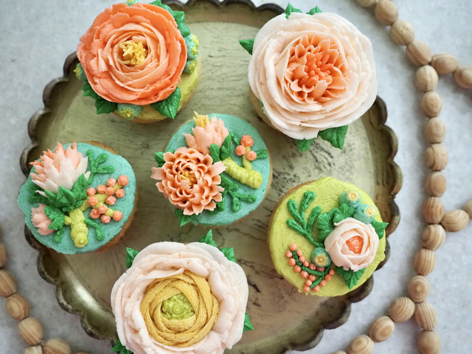 Set of buttercream cupcakes with floral designs on them