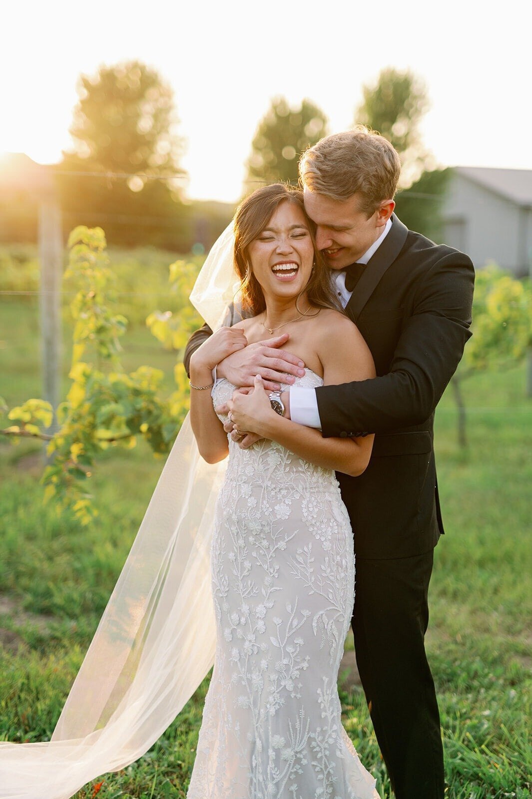 bride and groom outside at sunset on wedding day in minneapolis outside vineyard photographed by bauer creative