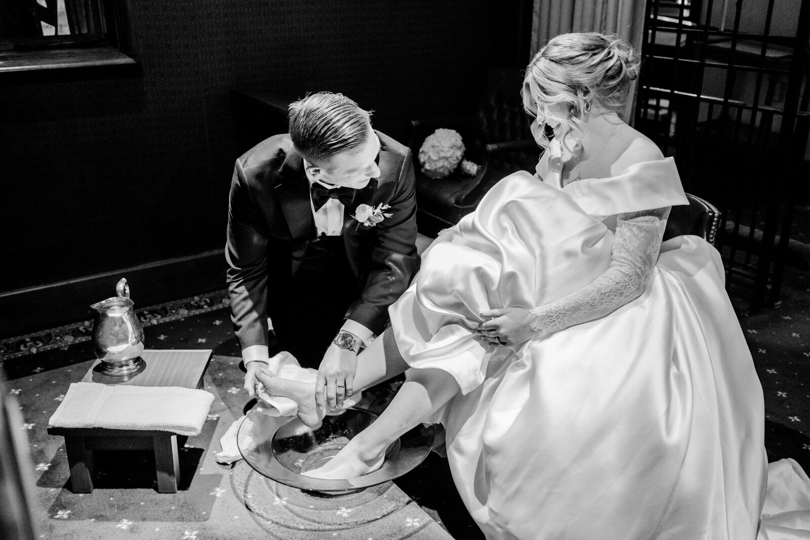 A groom washing the feet of his bride after their Catholic wedding in Washington DC
