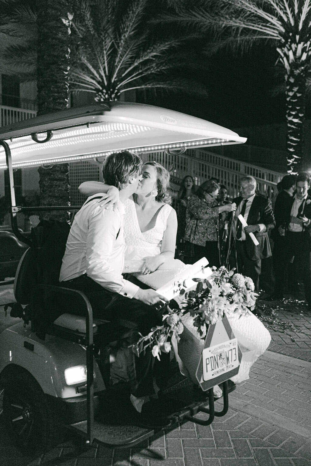 Bride and groom on golf cart at wedding reception at santa rosa beach florida